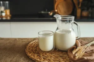 Fresh, natural milk in a glass and a pitcher at home