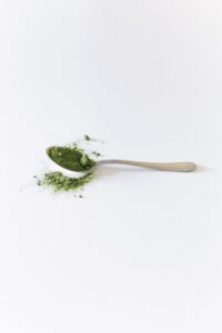 Matcha green tea powder in a spoon for matcha powder packaging