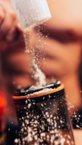 Protein powder scooped into a shaker for protein powder packaging