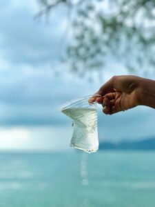 Hand holding a sealed water sachet produced by water sachet packaging machines